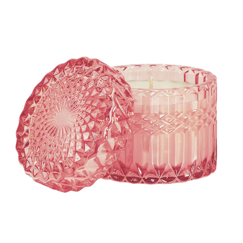 Pink Bellini 8oz Petite Shimmer Candle in a shimmering glass jar, glowing with a soft, radiant light. Infused with the bubbly scent of champagne, juicy peach, and ripe mango, this luxury soy wax candle creates a festive and uplifting ambiance. Perfect for home décor, celebrations, and gifting.