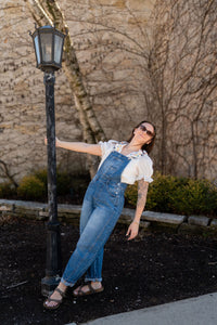 White ruffle and embroidered blouse paired with barrel overalls for a boho outfit for women