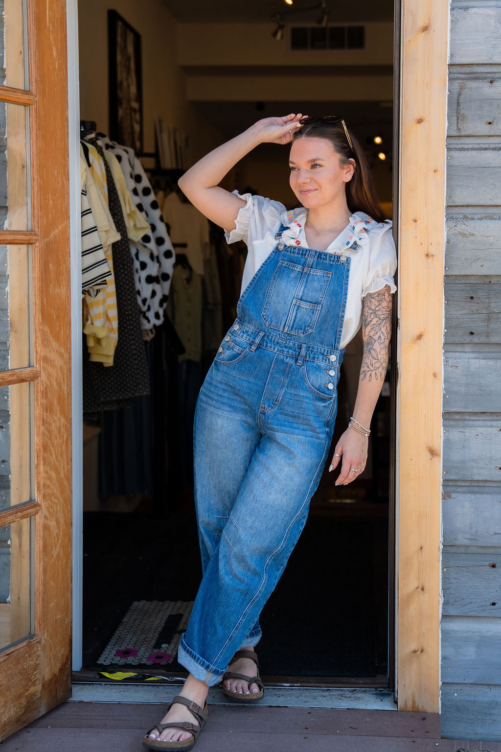 white ruffle embroidered boho blouse paired with denim barrel overalls