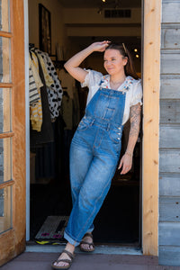 white ruffle embroidered boho blouse paired with denim barrel overalls