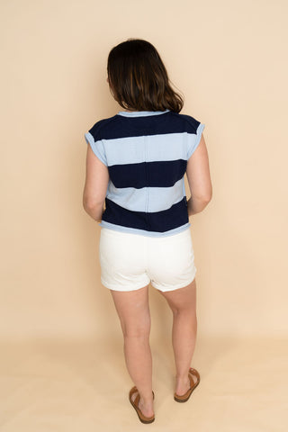 Navy striped short sleeve knit sweater top paired with white denim shorts for a cute resort vacation outfit