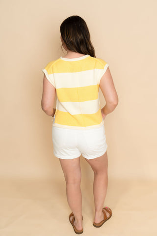 Short sleeve yellow striped sweater paired with white denim shorts for a cute casual resort outfit
