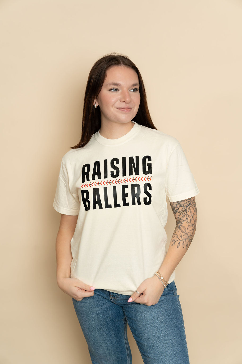 Ivory Raising Ballers graphic tee styled for a casual everyday outfit from Wild Lavender Boutique. 