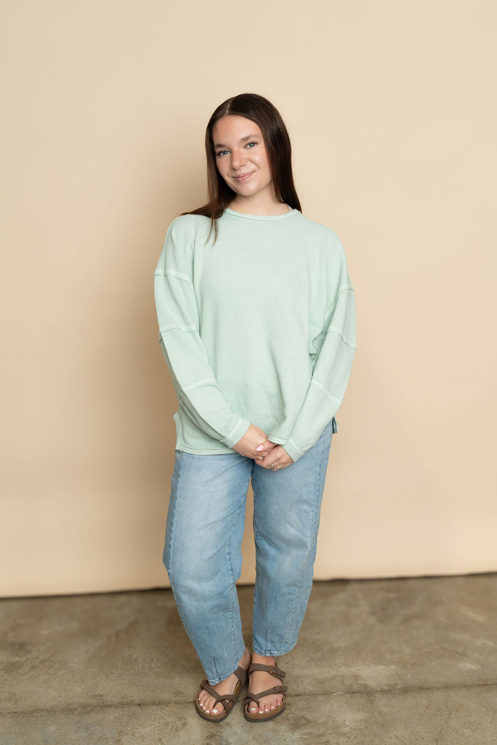 Mint long sleeve casual top paired with light wash barrel jeans for a casual outfit for women. 