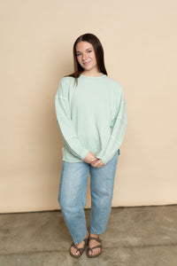 Mint long sleeve casual top paired with light wash barrel jeans for a casual outfit for women. 