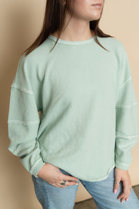 Close view of mint long sleeve casual top for women. 