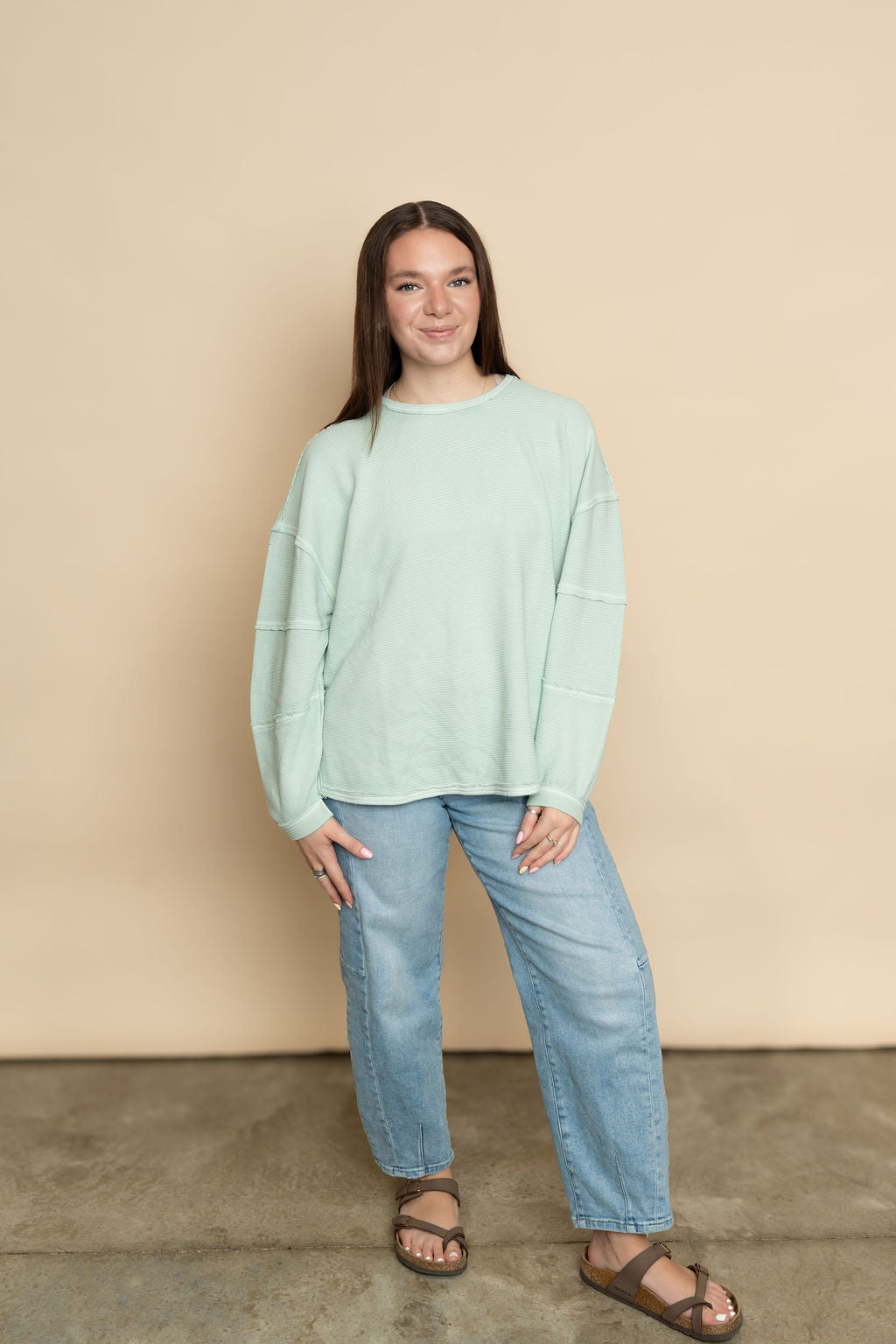 Mint basic long sleeve top paired with light wash barrel jeans for a casual outfit for women. 
