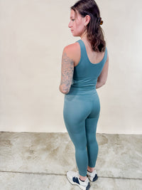 Back view of green cloud soft leggings. 