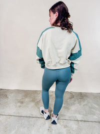 Back view of green contrast stitch sweatshirt. 