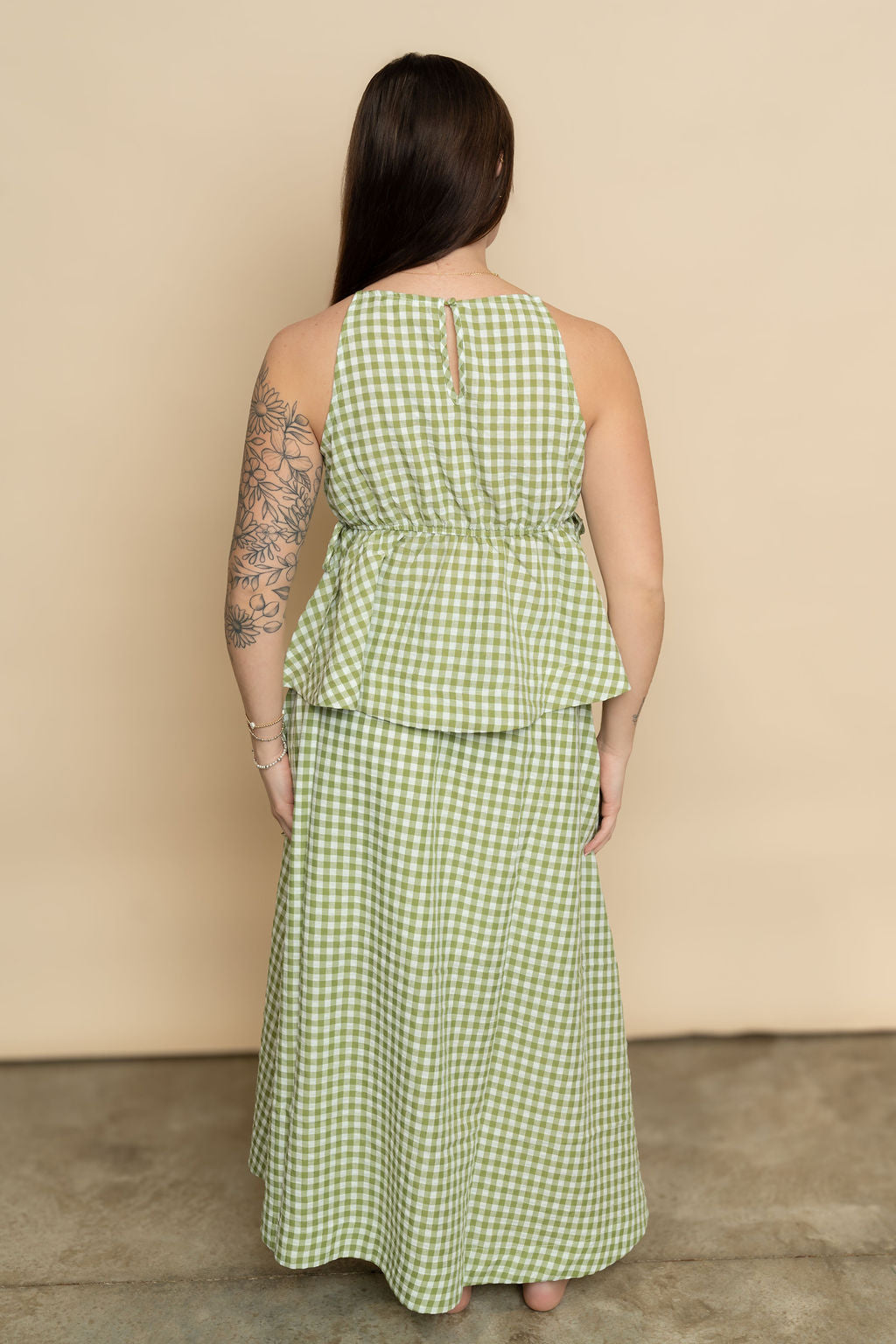 Back view of sage green gingham maxi skirt paired with matching sage gingham tank top for a cute casual easter outfit for women. 