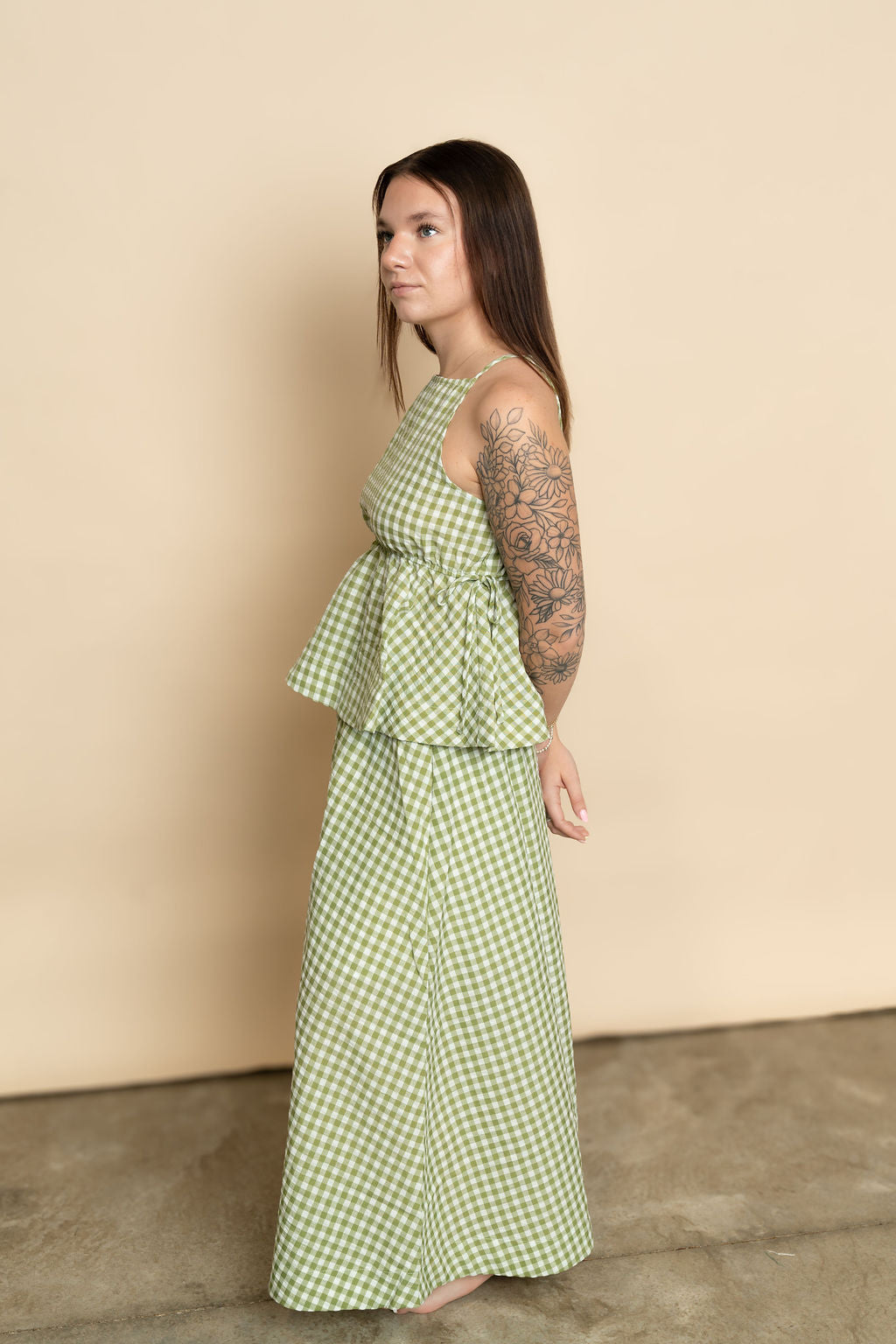Side view of sage green gingham maxi skirt paired with matching sage gingham tank top for a cute casual set for women. 