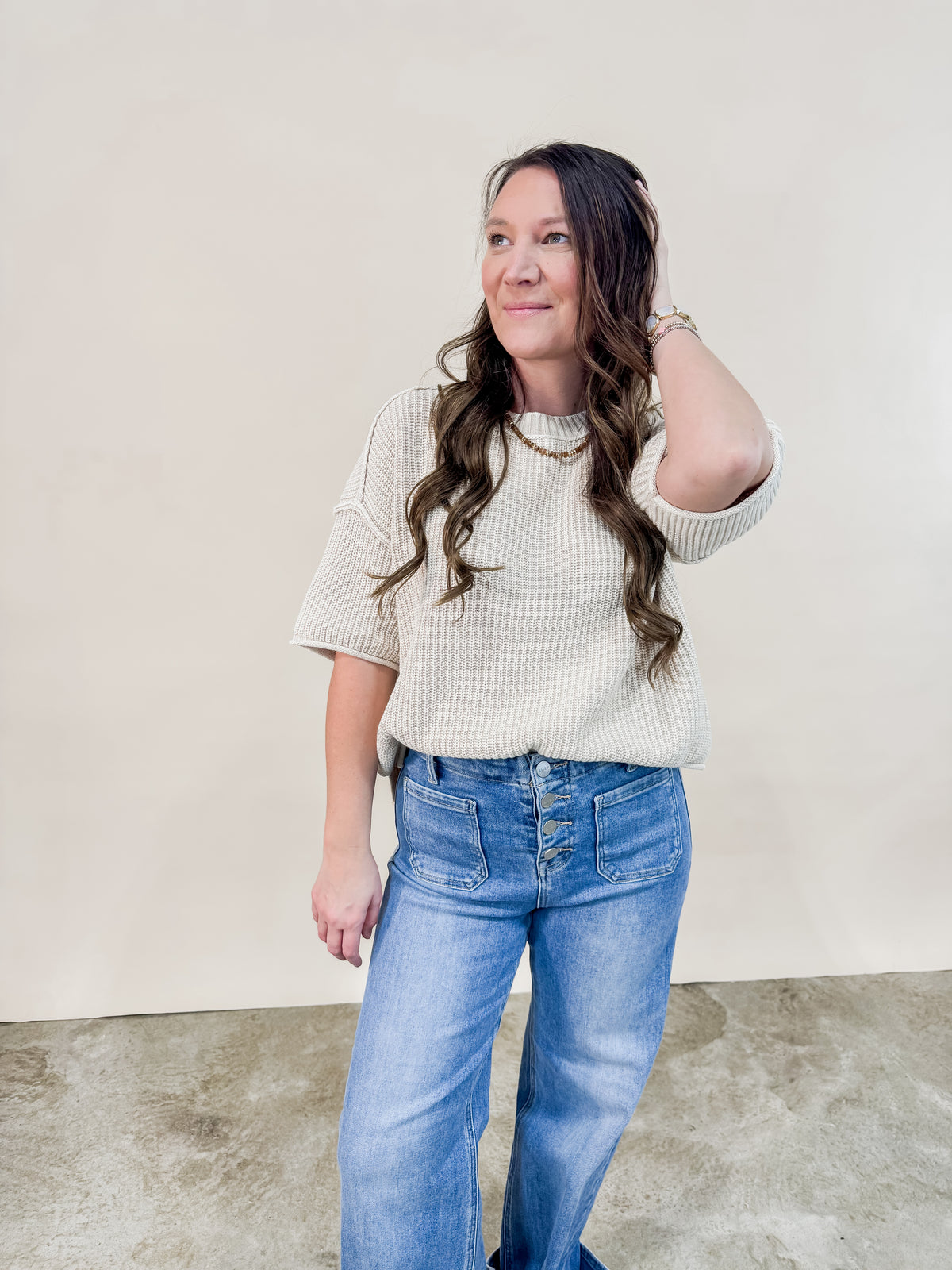 Ivory knit short sleeve sweater paired with Risen cuffed high rise denim jeans for a casual neutral outfit. 