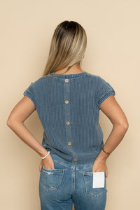 Back view of blue knit short sleeve sweater with button down back. 