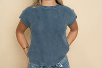 Closeup of blue knit short sleeve sweater. 