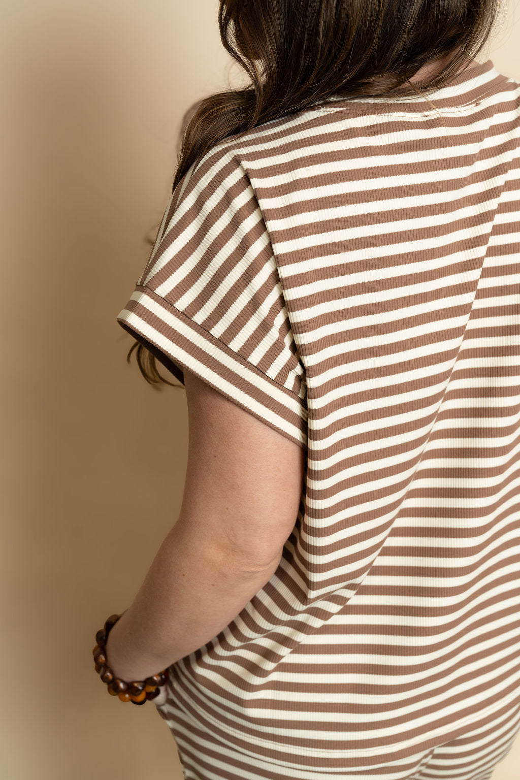 Close up of brown and cream striped lounge set for women. 
