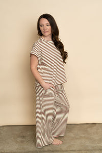 Side view of brown and cream lounge set for women. 