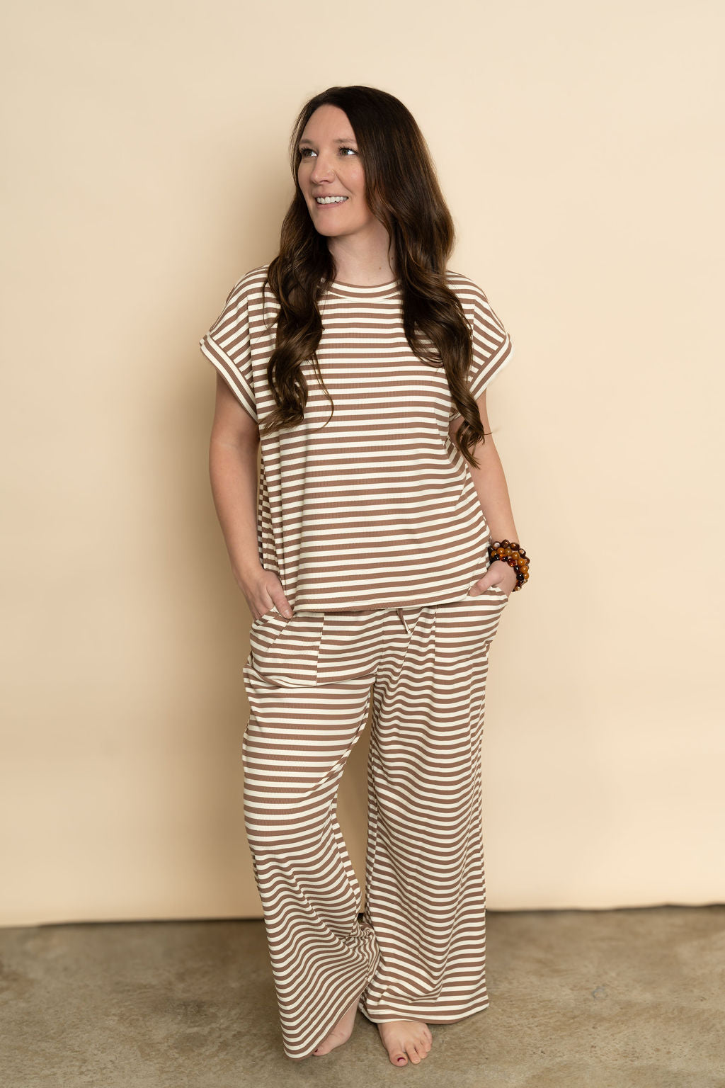 Brown and cream striped lounge set featuring short sleeve top and long pant bottoms for a cozy casual outfit. 