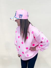 Side view of make heaven crowded trucker hat. 