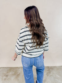 Back view of oversized ivory and black striped tee. 