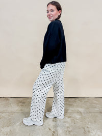 Back view of black & white polka dot wide leg jeans. 