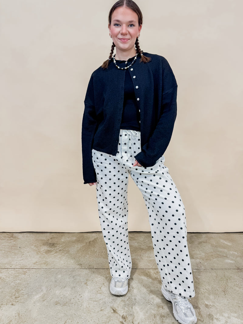 Black & White polka dot wide leg pants paired with a black cardigan for a cute casual outfit for women. 