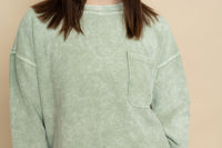 Closeup of ribbed long sleeve top in sage.