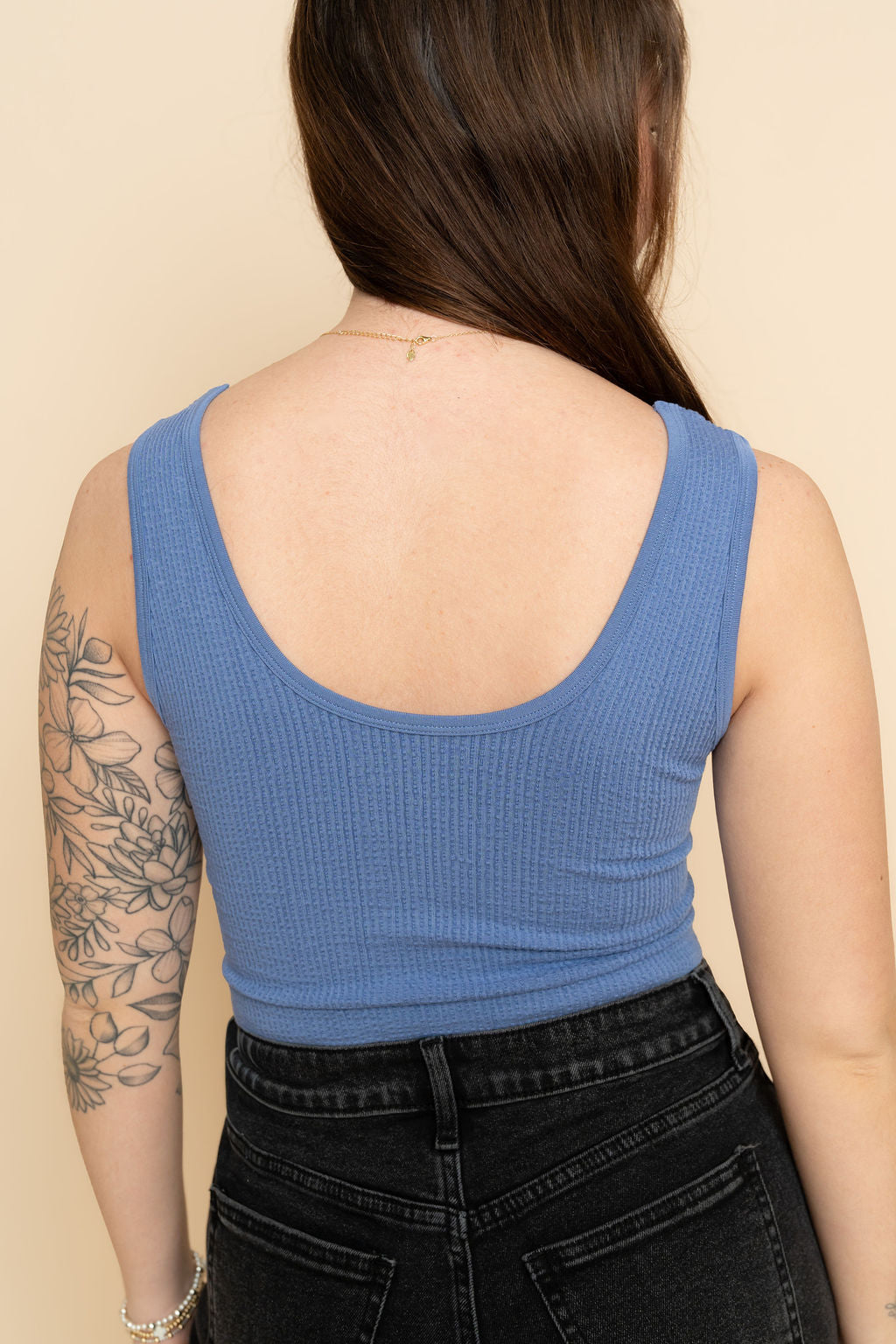 Back view of women's blue seamless cami tank top. 