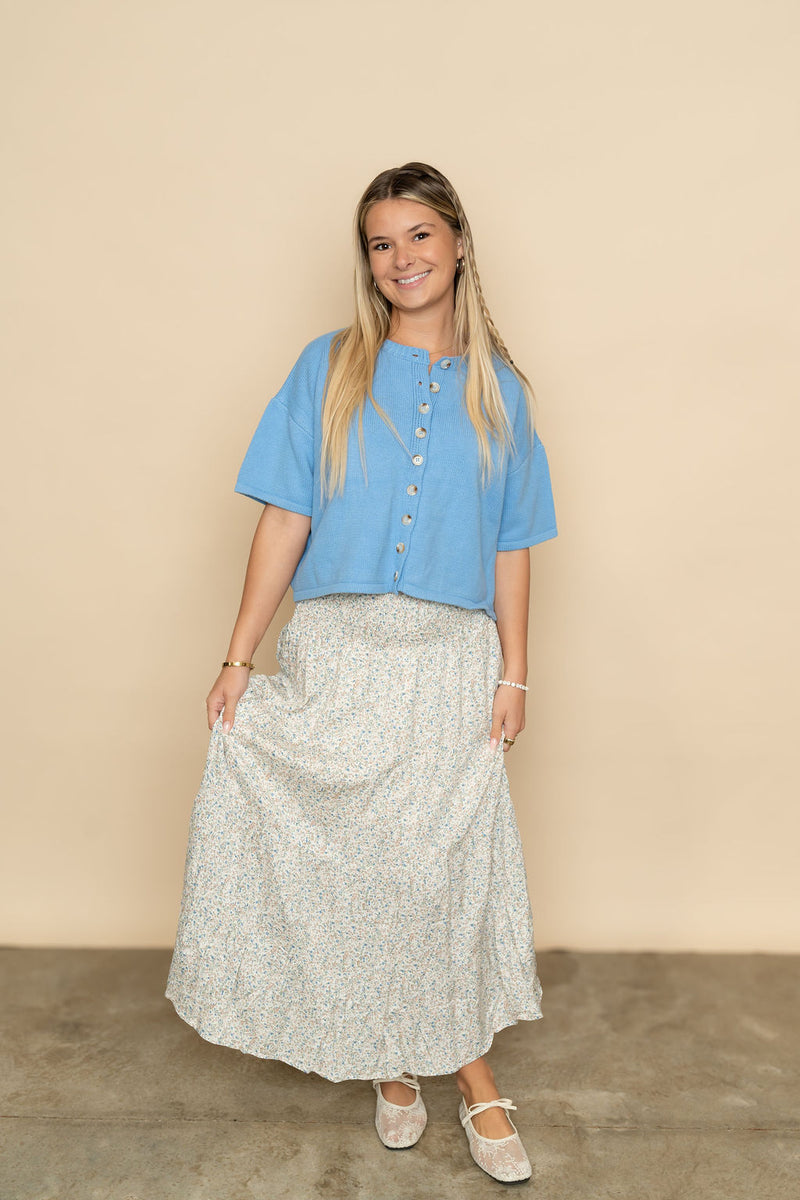 Blue short sleeve cardigan sweater paired with floral maxi skirt for a cute spring outfit for women. 