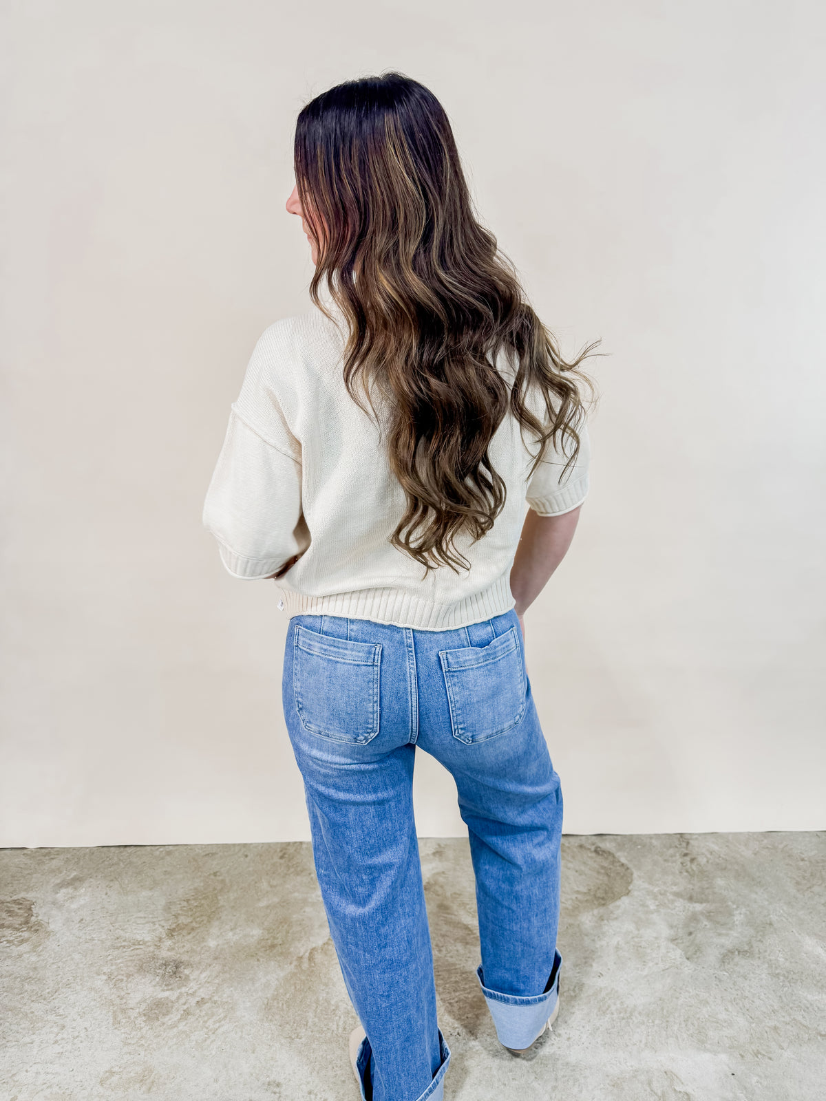 Back view of ivory short sleeve cardigan. 