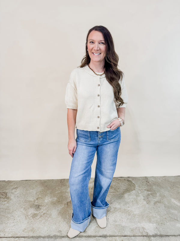 Ivory short sleeve cardigan paired with cuffed denim jeans for a casual spring outfit. 