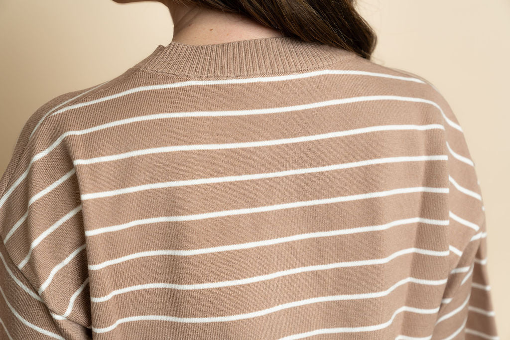 Closeup of brown and white striped sweater top. 