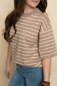 Closeup of brown and white short sleeve striped sweater top for women. 