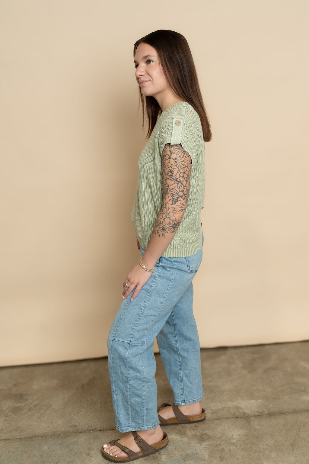 Side view of sage green knit short sleeve sweater top for women. 