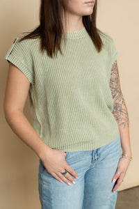 Closeup of sage green knit short sleeve sweater. 