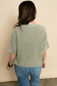 Back view of sage short sleeve knit sweater. 