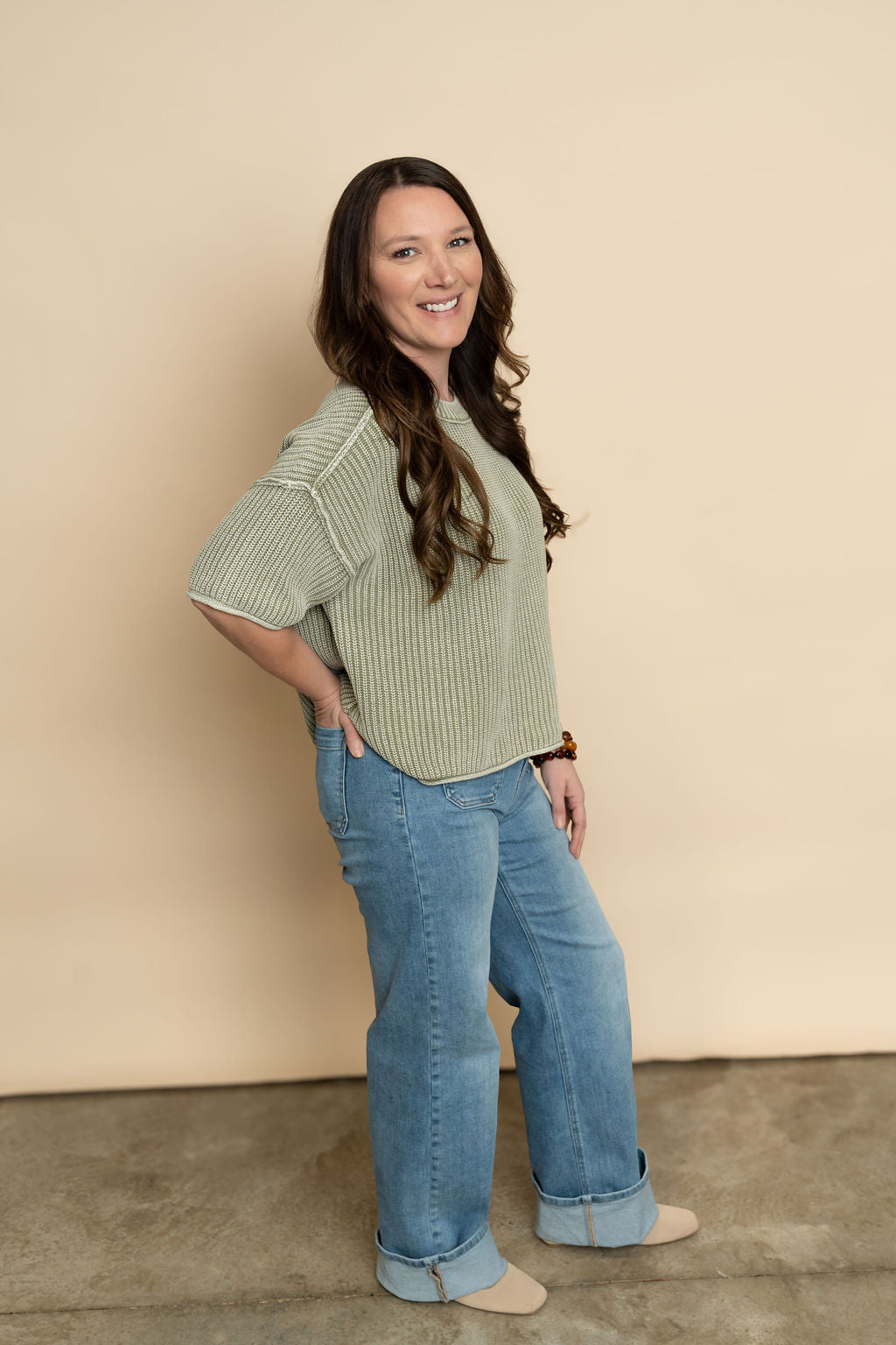Sage short sleeve knit top paired with light wash wide leg jeans for a casual outfit for women. 