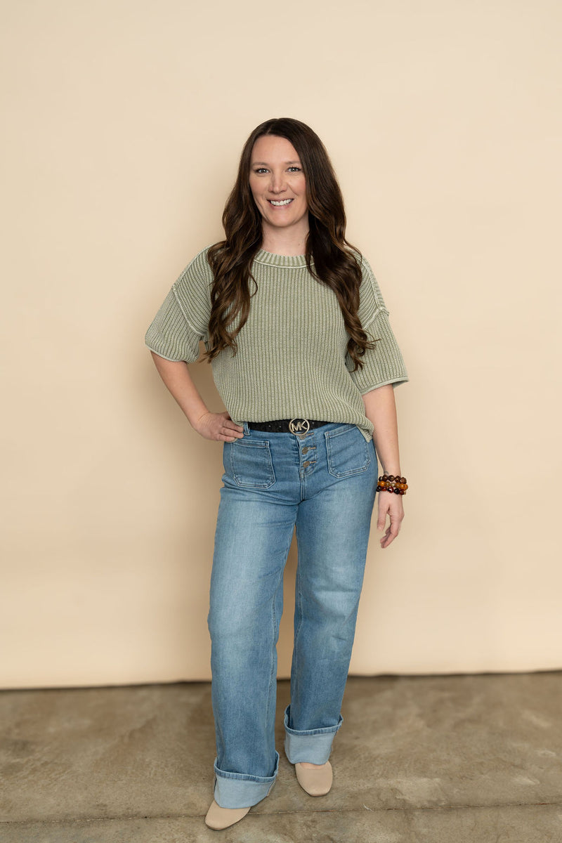Sage knit short sleeve sweater paired with wide leg cuffed jeans for a casual spring outfit for women. 