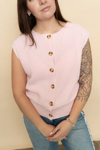 Pink sleeveless knit sweater vest for a casual spring outfit.