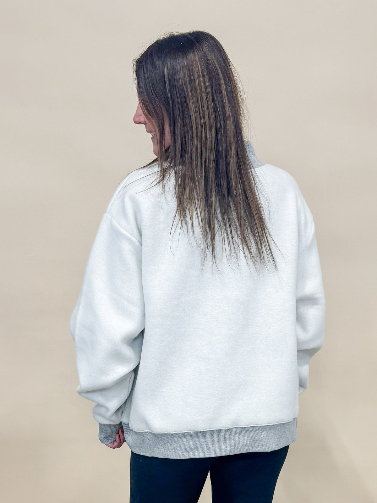 Back view of heather gray reversible worship and polka dot mock neck sweatshirt. 