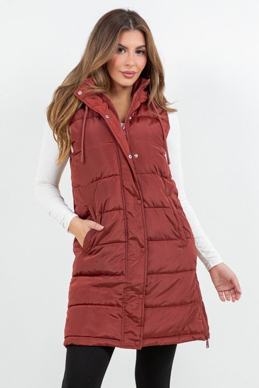 Woman wearing a red puffer vest on a white background